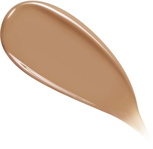 A spoon with light brown creamy substance, possibly peanut butter or caramel sauce.