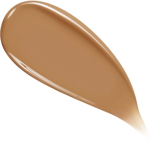 A swoosh of smooth, brown liquid, syrup-like, drops off at one end.