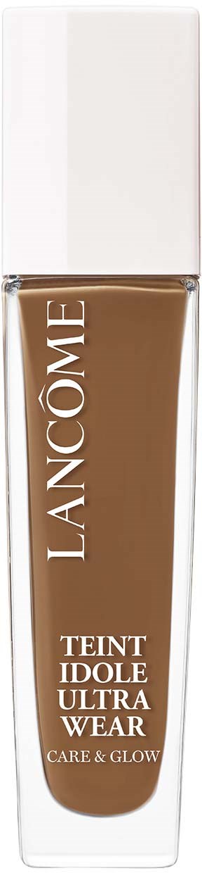A brown liquid foundation in a clear bottle with a white cap. The brand name 'Lancôme' and product details are on the bottle.