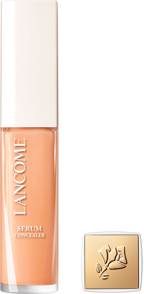 A bottle of Lancôme serum concealer with a white cap and gold compact beside it.