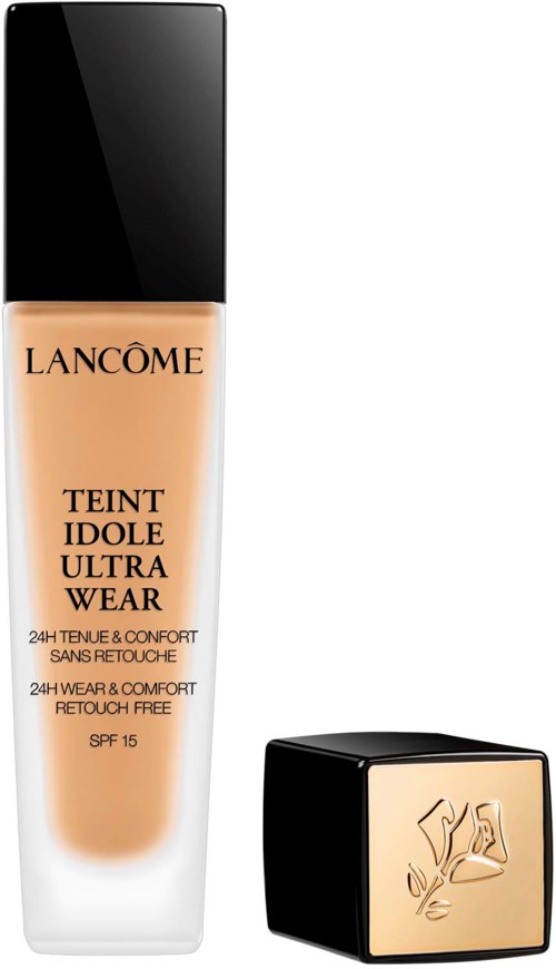 En Lancôme foundationflaska med svart lock och en liten svart och guld kvadratförpackning bredvid.