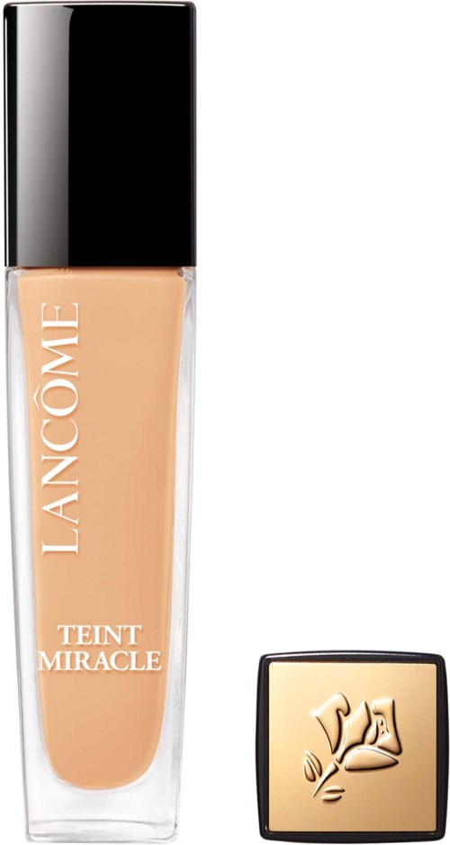 A bottle of Lancôme Teint Miracle foundation with a beige liquid inside and a gold-colored cap.