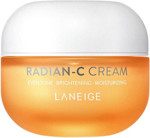 Een kleine oranje pot met witte deksel, met label 'RADIANCE C CREAM', voor egaliseren, hydrateren en opfrissen van de huid.