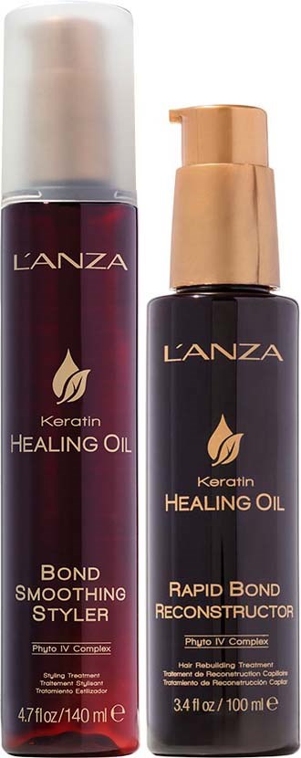 Kaksi L'ANZA Keratin Healing Oil -tuotetta, toinen silottava ja toinen korjaava, pumppupulloja.