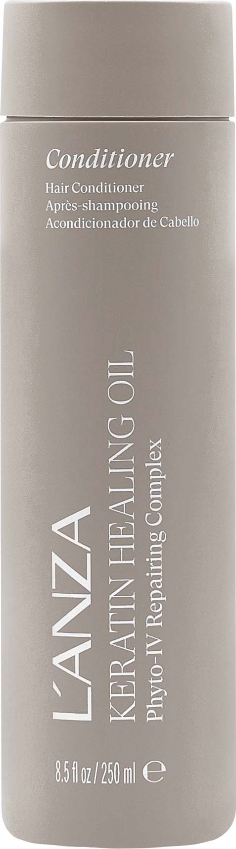 En lång grå flaska med hårbalsam märkt Lanzan Keratin Healing Oil. Texten betonar att den reparerar och ger näring åt håret.