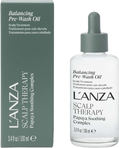 En klar glassflaske med pipette som inneholder Balancing Pre-Wash Oil for hodebunnsberoligende behandling, merket av L'ANZA.