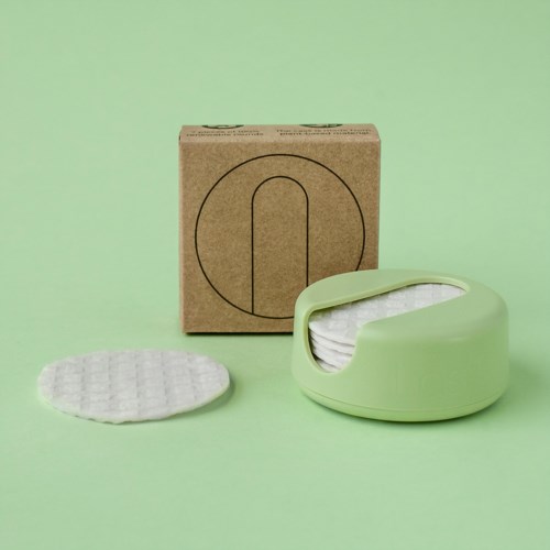 A green case with cotton pads, and a cardboard box with a circle and line logo.