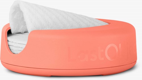 Eine rosa automatische Taschentuchbox mit einem Papier, das teilweise herausgezogen ist.