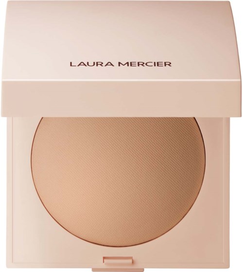 En rund beige kompakt med ett matchande ljusrosa skal, märkt 'LAURA MERCIER'.
