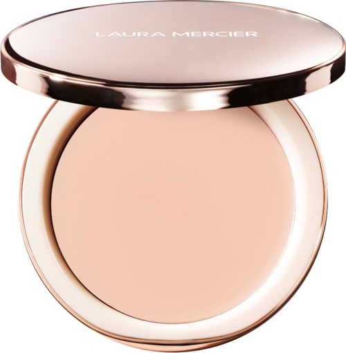 A compact with creamy beige powder inside, sealed with a shiny rose gold lid, labeled Laura Mercier.
