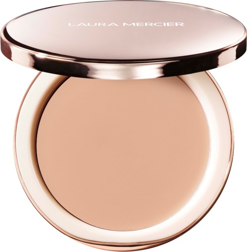 A compact makeup powder with a rose gold case and the brand Laura Mercier on the lid.