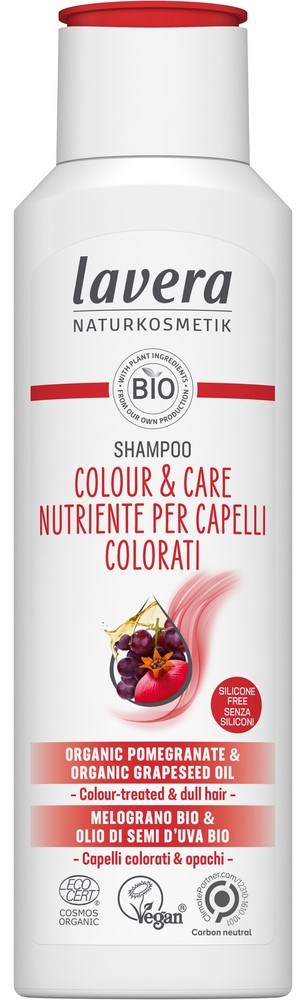 A white bottle of Lavera shampoo with red and black text, showing organic pomegranate and grapeseed oil ingredients.