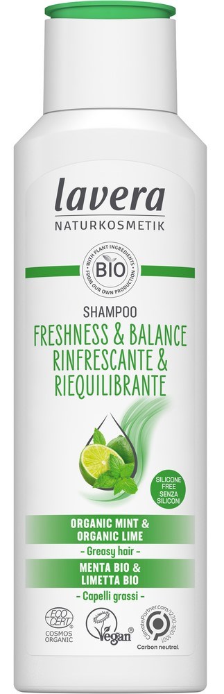 A white shampoo bottle with green cap, labeled Lavera Organic Mint & Lime, promoting freshness and balance for hair.