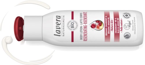 A white bottle with red and gray text, lying on its side, with a swirl of cream coming out.