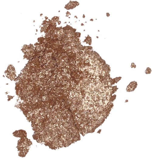 Kopparfärgad pulver med en grov textur, spridd runt. Det ser ut som ett mineral eller metalliskt damm.