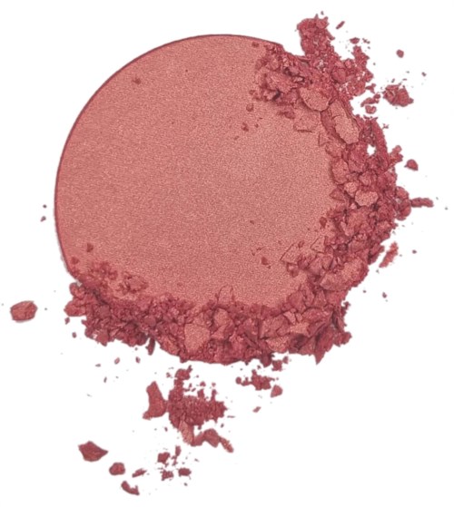 The image shows a circular pink makeup blush with some powder scattered around it.