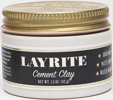 A small white jar with a gold lid labeled Layrite Cement Clay, with details about hold, shine, and water resistance.