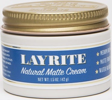 A white jar with a gold lid labeled 'Layrite Natural Matte Cream' for hair styling.