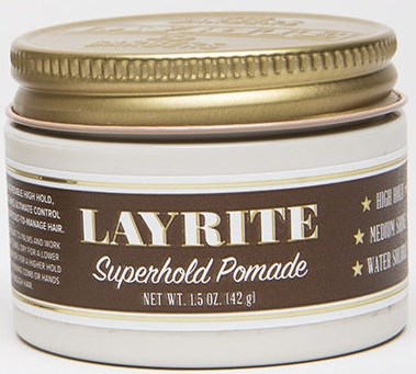 A round container labeled 'Layrite Superhold Pomade' with a gold lid, used for hair styling.