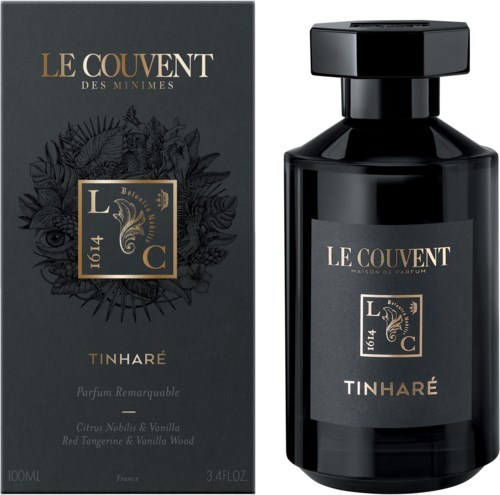 Een zwarte parfumfles en doos met gouden en witte tekst, met een zeepaardje-logo en productnaam Tinharé.