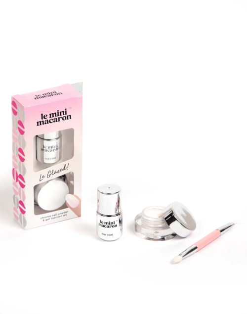 A pink and white mini manicure set includes nail polish, cream, brush, and box for small beauty care.