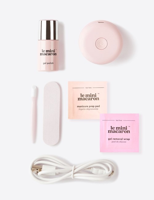 A nail care kit including gel polish, a mini lamp, files, pads, a removal wrap, a cuticle stick, and a USB cable.