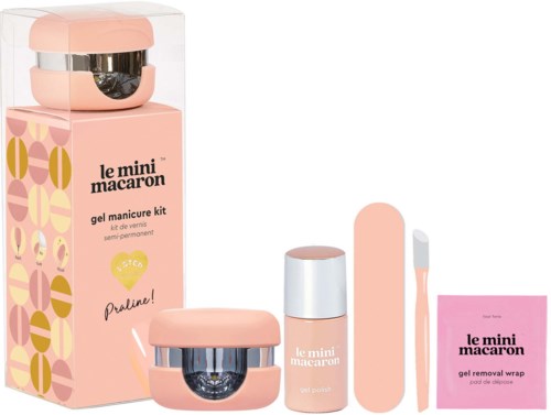 A pink manicure kit with gel, tools, and a wrap label, all arranged neatly on a white background.