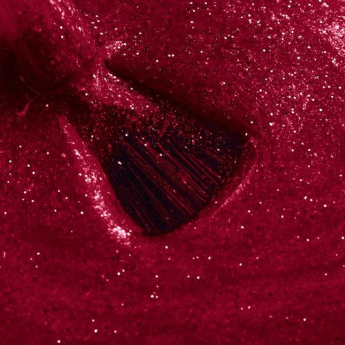 A red, glittery surface with a dark, striped opening or hole in the center.