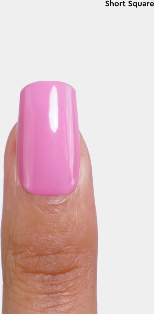 A fingernail painted bright pink on a thumb. The background is white with some text at the top.