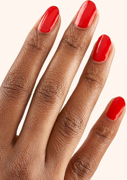Hand with red painted nails, smooth skin, and natural texture.