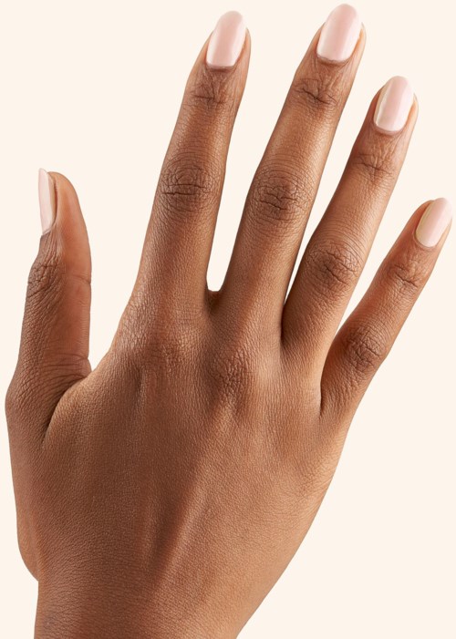 A hand with well-groomed nails, showing natural skin tone and smooth skin.