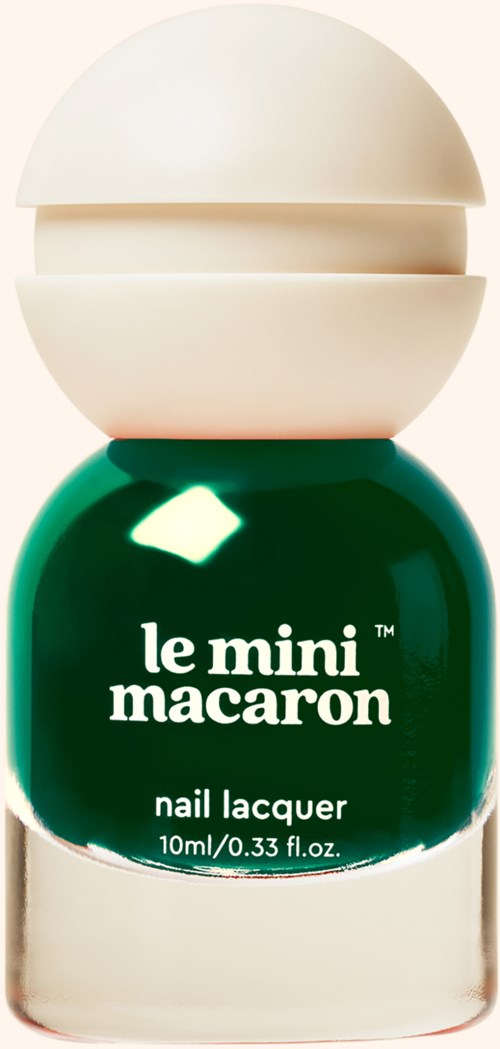 A green nail polish bottle with a white cap and label that says 'le mini macaron nail lacquer.'