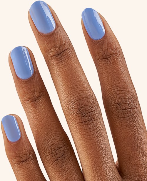 Four fingers with light blue painted nails against a light background.