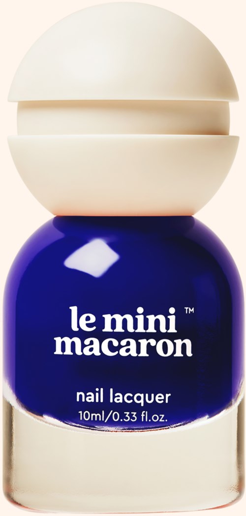 A small bottle of dark blue nail lacquer with a white lid that opens. The label says "le mini macaron."