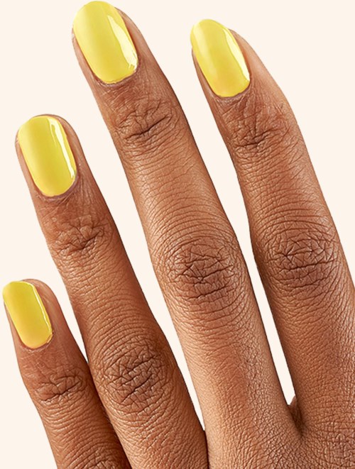 Hand with yellow painted nails, showing close-up detail of fingers and skin.