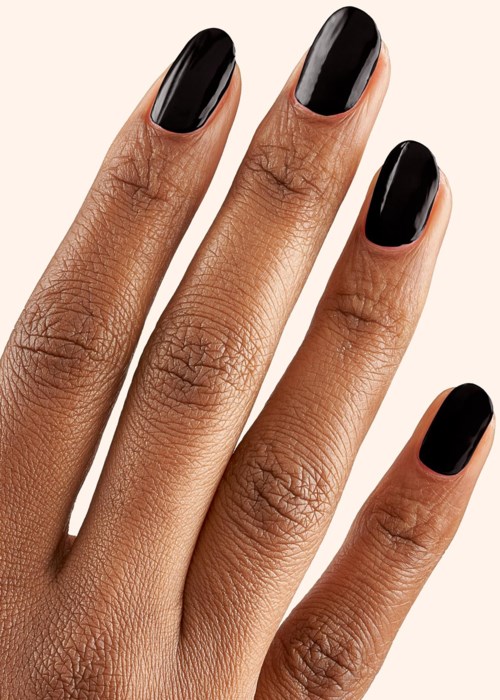 A hand with dark, shiny nail polish on all five nails, against a light background.