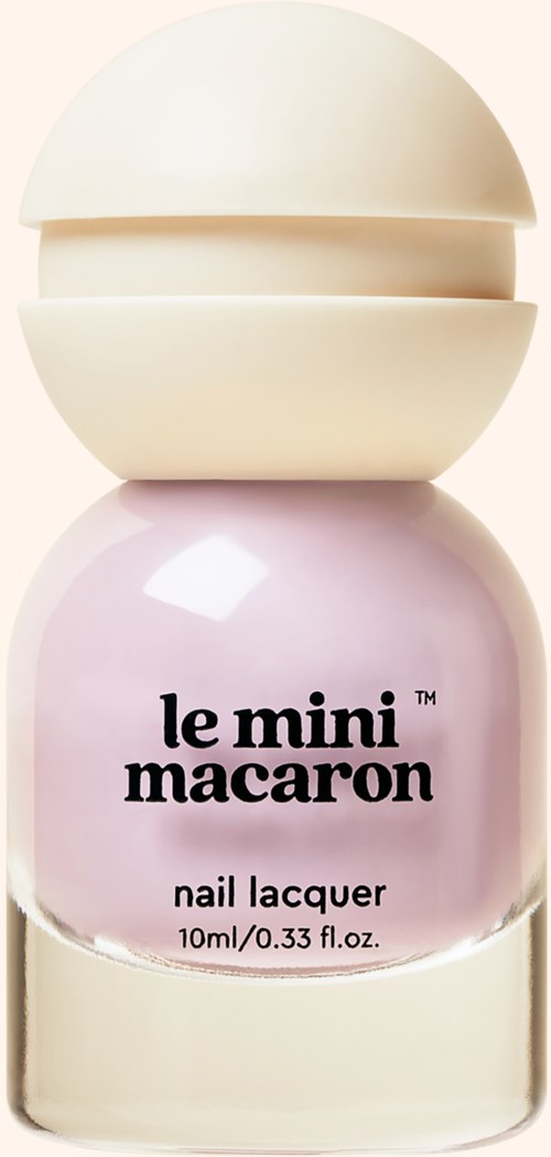Pink nail polish bottle labeled 'le mini macaron nail lacquer'. Rounded cap and simple design.