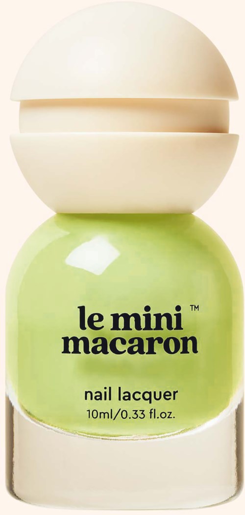 A bottle of green nail polish labeled "le mini macaron nail lacquer" with a two-part white cap.
