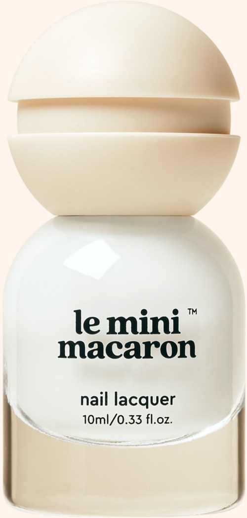 A small bottle of nail polish labeled "le mini macarons" with a beige cap and white liquid inside.