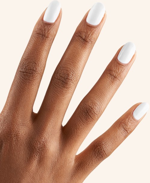 A hand with neatly nail-polished fingers, nails painted white, fingers spread apart.