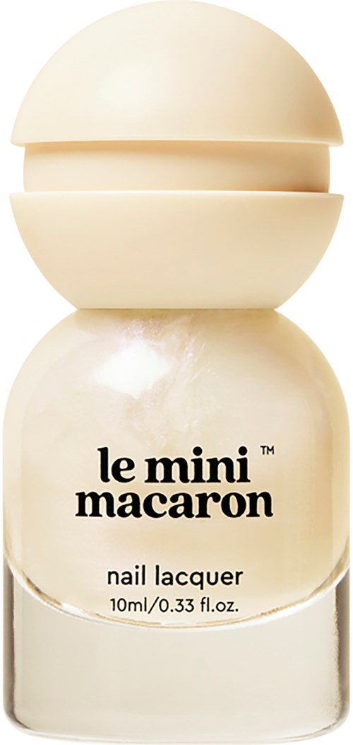 A small bottle of beige-colored nail polish with a round cap, labeled 'le mini macaron nail lacquer'.