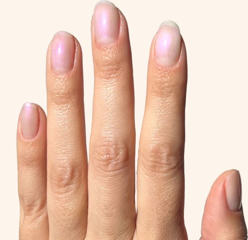 A close-up of a hand with clean, short nails and smooth skin.