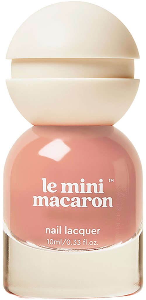A pastel pink nail polish bottle with a cream-colored cap shaped like a macaroon.