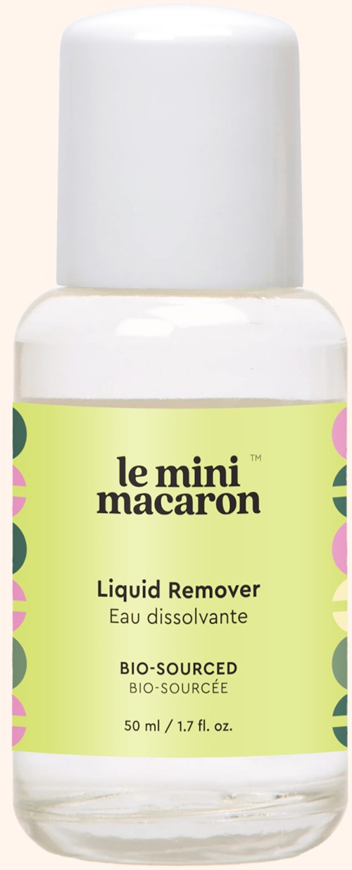 A small bottle of liquid remover labeled 'le mini macaron' with green and pink decorative accents.