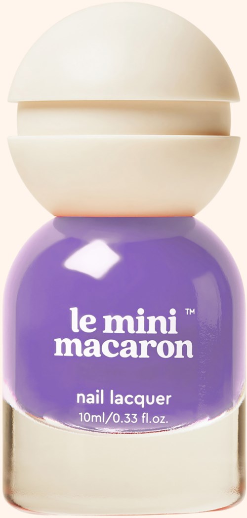 Purple nail polish bottle labeled 'le mini macaron' with a beige cap. Compact and round in shape.