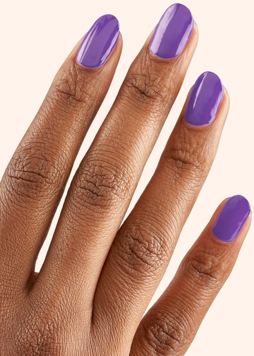 A hand with five fingers has purple-painted nails.