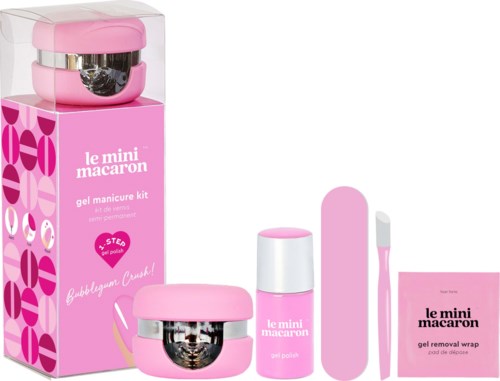 Pink manicure kit with gel polish, UV lamp, and brush, packaged in a pink box.