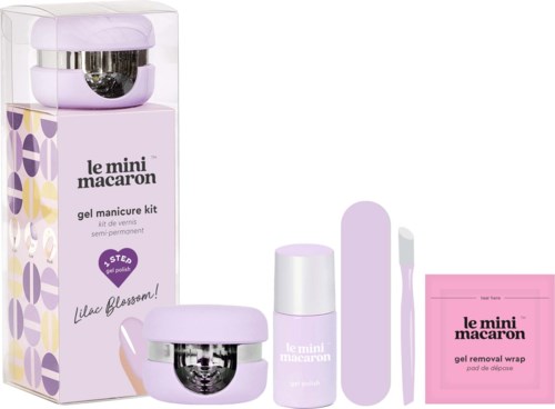 En nagelvårds-sets med lila och vita produkter, inklusive gelborttagare, två verktyg och en låda.