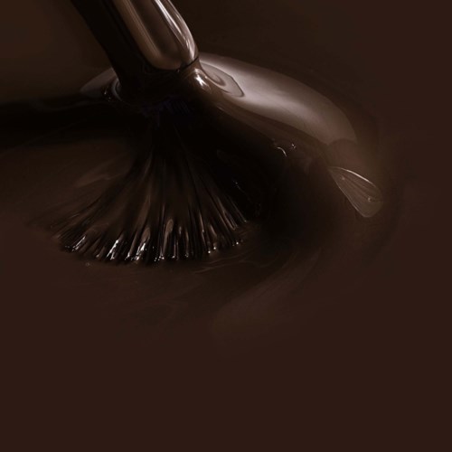 Dark liquid being stirred with a brush or spatula, creating ripples and mixing thoroughly.