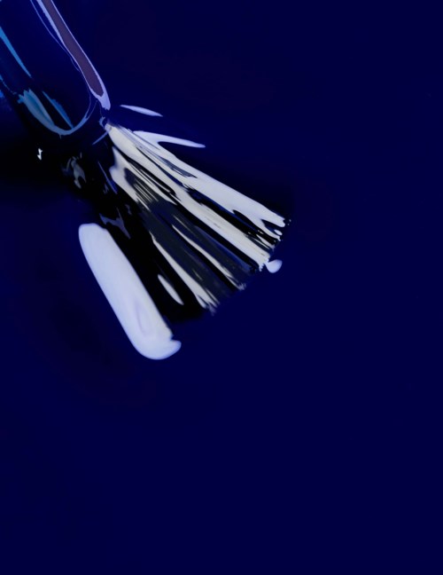 An abstract design with black and white streaks on a dark blue background, resembling artistic brush strokes.